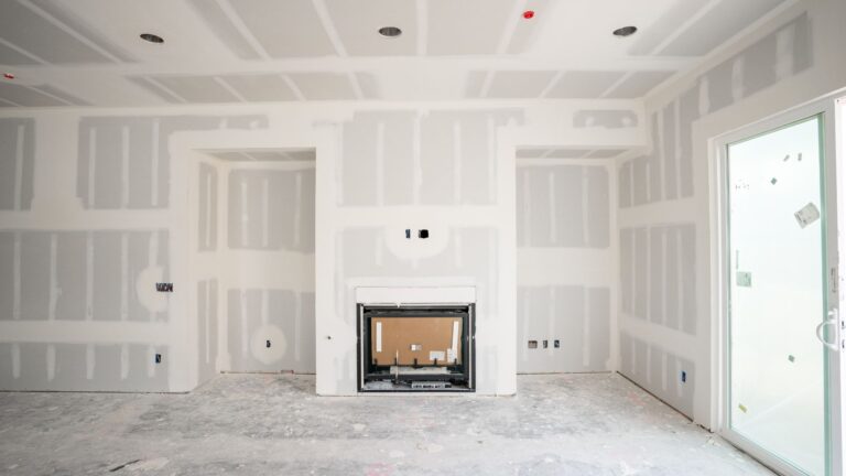 New drywall installed around a fireplace
