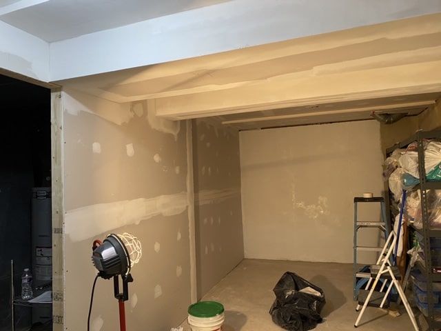 Basement area under the stairs during drywall work