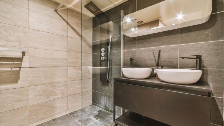 Modern bathroom with double vessel sinks and a glass shower